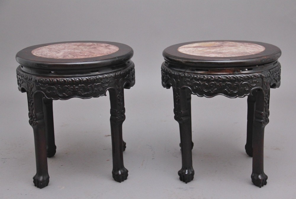 A pair of 19th-century Chinese carved dark hardwood circular occasional tables with inset pink marble tops and carved legs. View VIII