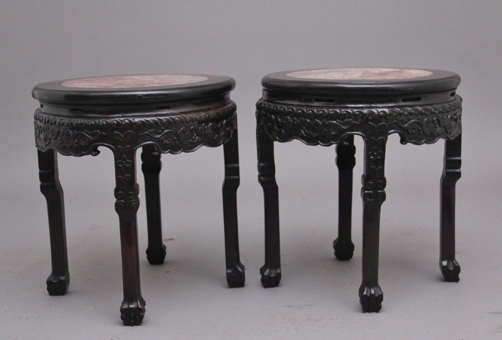 A pair of 19th-century Chinese carved dark hardwood circular occasional tables with inset pink marble tops and carved legs. View XI