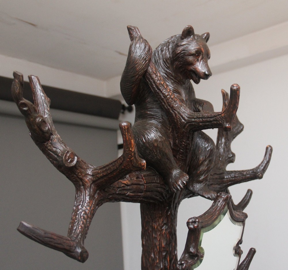 A 19th-century hand-carved Black Forest hall stand featuring two carved bear figures, branch-form coat hooks, small mirrors, and an umbrella ring base. View III