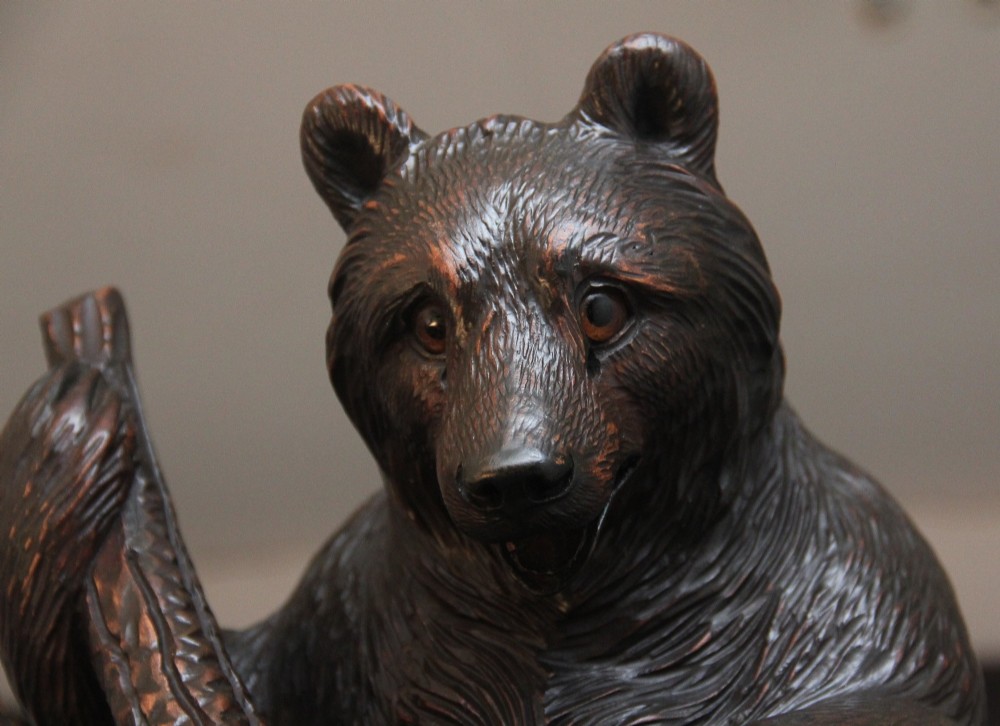A 19th-century hand-carved Black Forest hall stand featuring two carved bear figures, branch-form coat hooks, small mirrors, and an umbrella ring base. View IV
