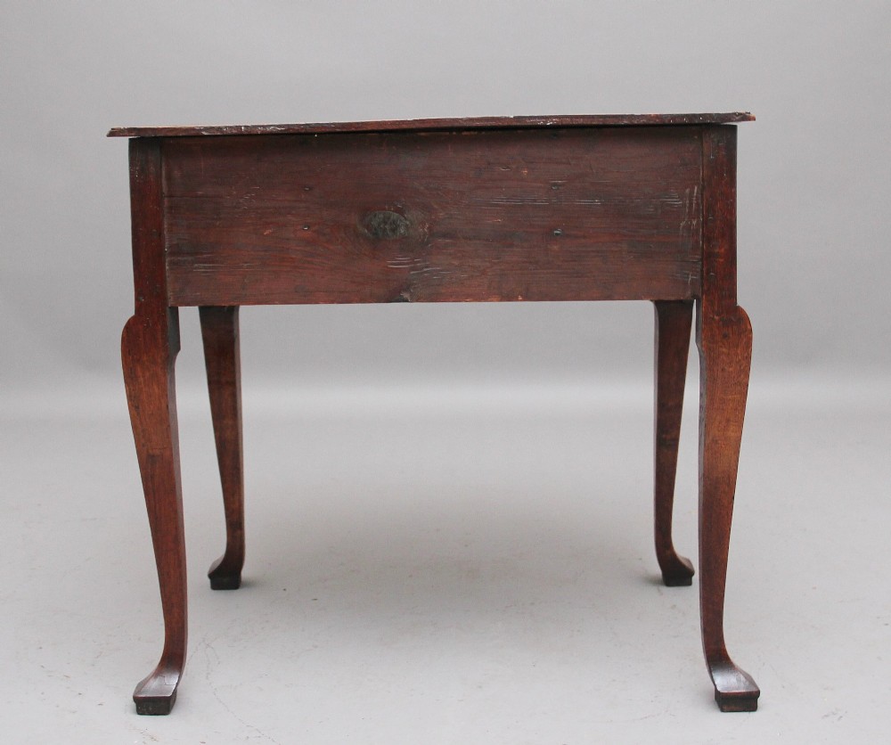 An 18th-century oak lowboy table featuring three drawers with brass handles, inlaid chevron borders, a scalloped apron, and four cabriole legs. View VI