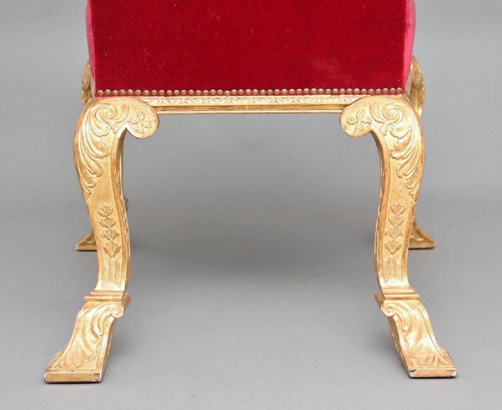A pair of George I style giltwood side chairs featuring carved mask motifs on the legs and upholstered in rich red patterned velvet. View VII
