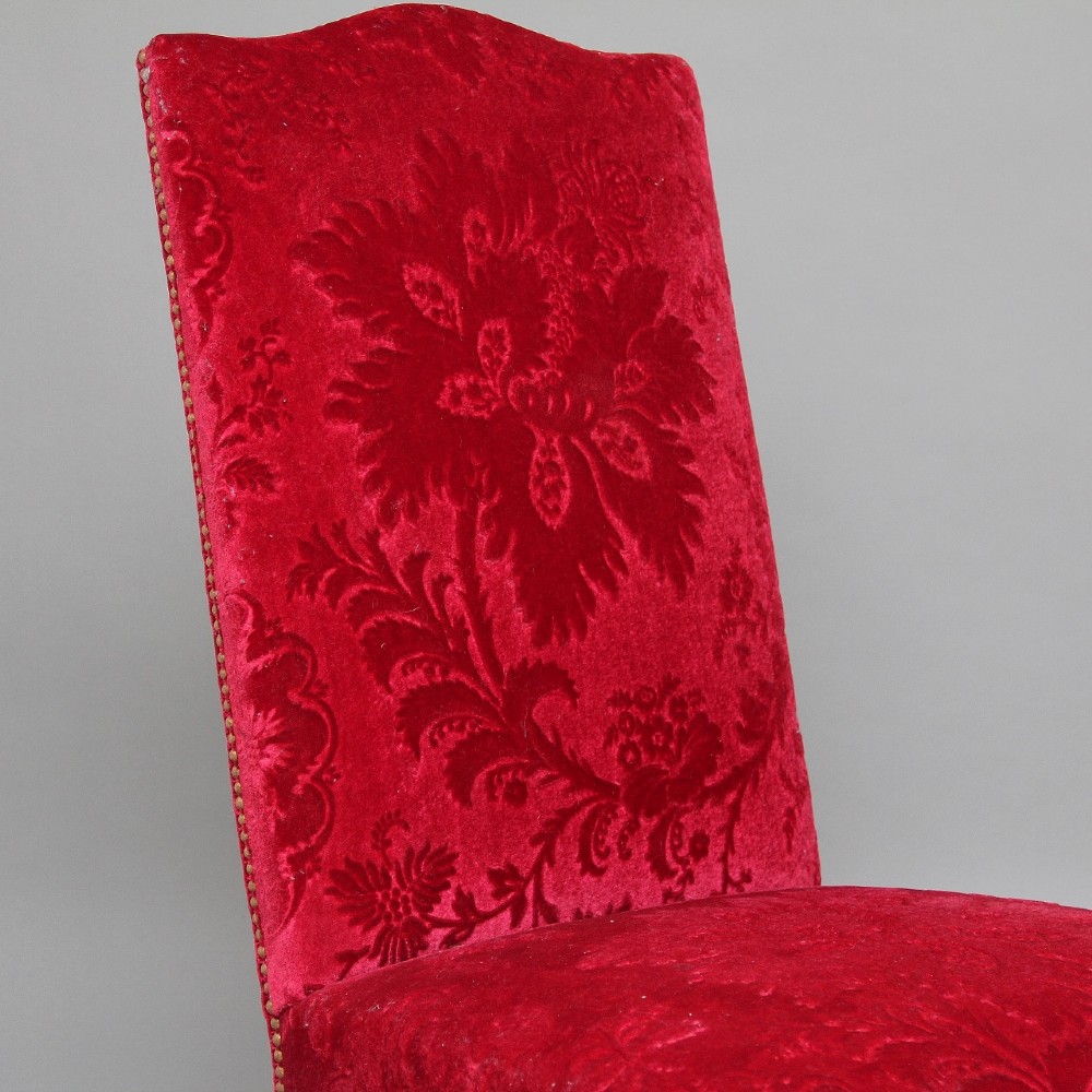 A pair of George I style giltwood side chairs featuring carved mask motifs on the legs and upholstered in rich red patterned velvet. View XII