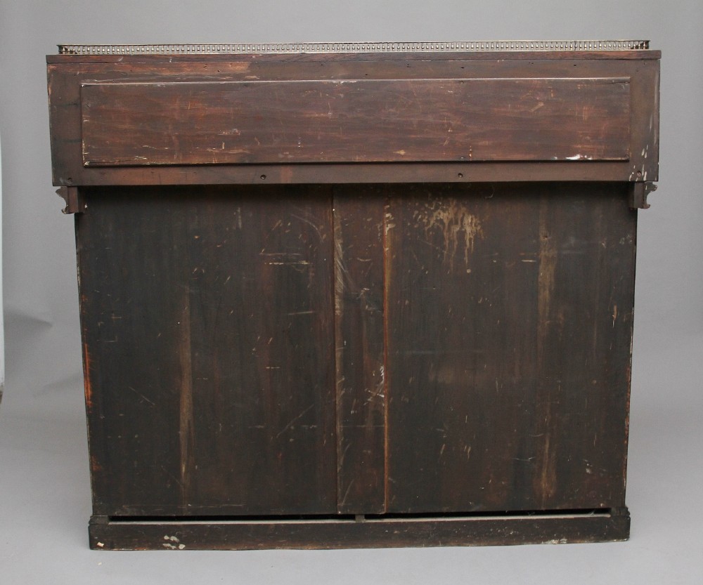 A nineteenth-century pollard oak cabinet featuring a mirrored gallery top, fluted column pillars, and twin doors with fabric-lined panels. View V