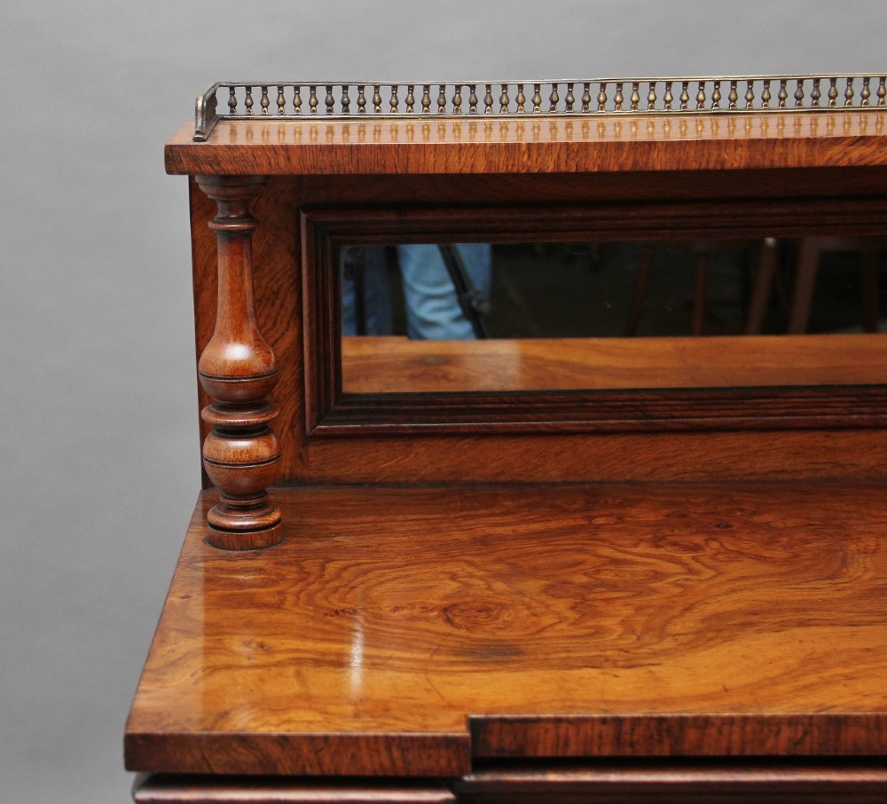 A nineteenth-century pollard oak cabinet featuring a mirrored gallery top, fluted column pillars, and twin doors with fabric-lined panels. View IX