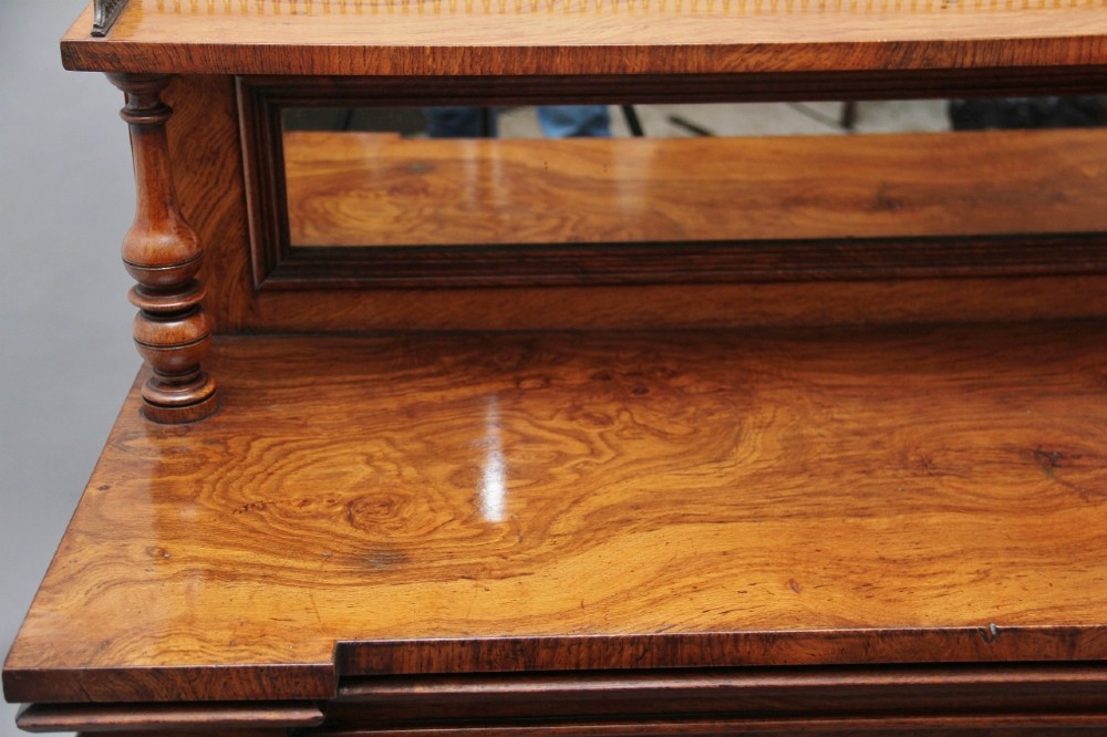 A nineteenth-century pollard oak cabinet featuring a mirrored gallery top, fluted column pillars, and twin doors with fabric-lined panels. View XI