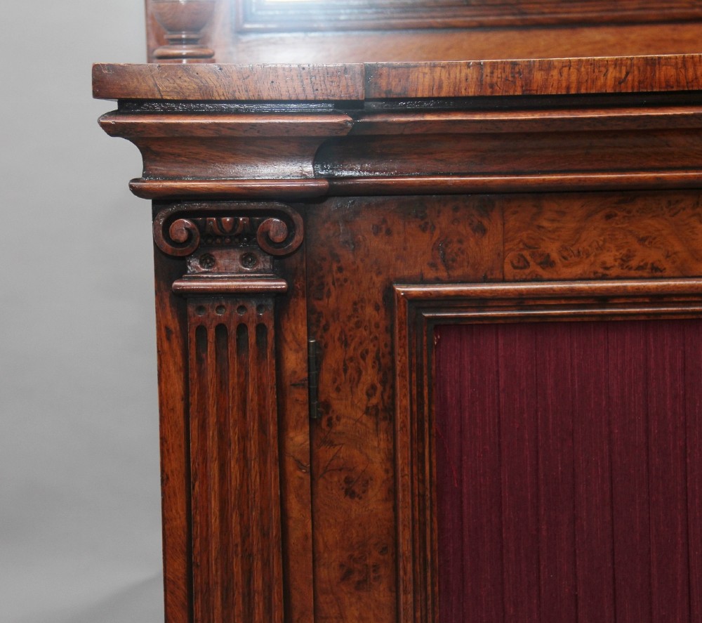 A nineteenth-century pollard oak cabinet featuring a mirrored gallery top, fluted column pillars, and twin doors with fabric-lined panels. View XIII