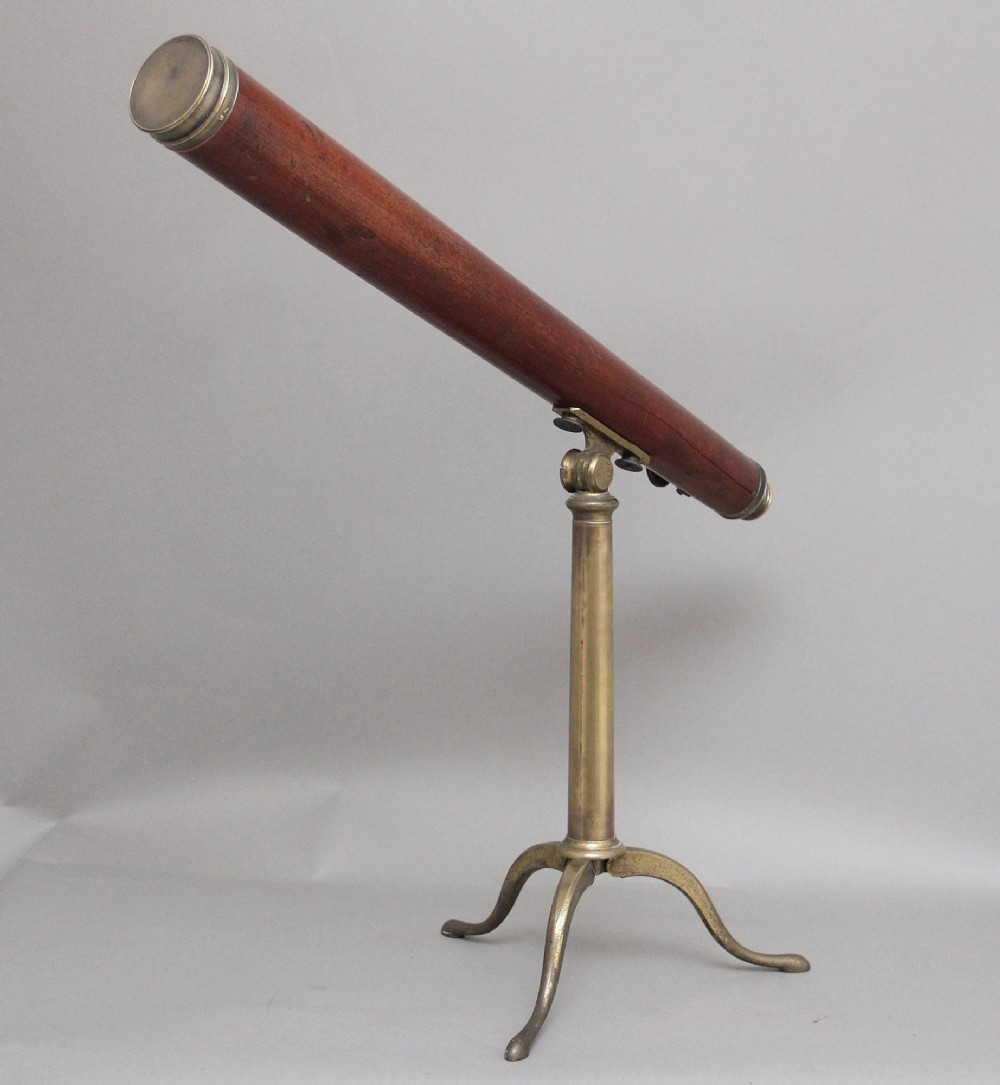 An 18th-century mahogany barrel telescope mounted on an adjustable brass column with a folding tripod base. View II