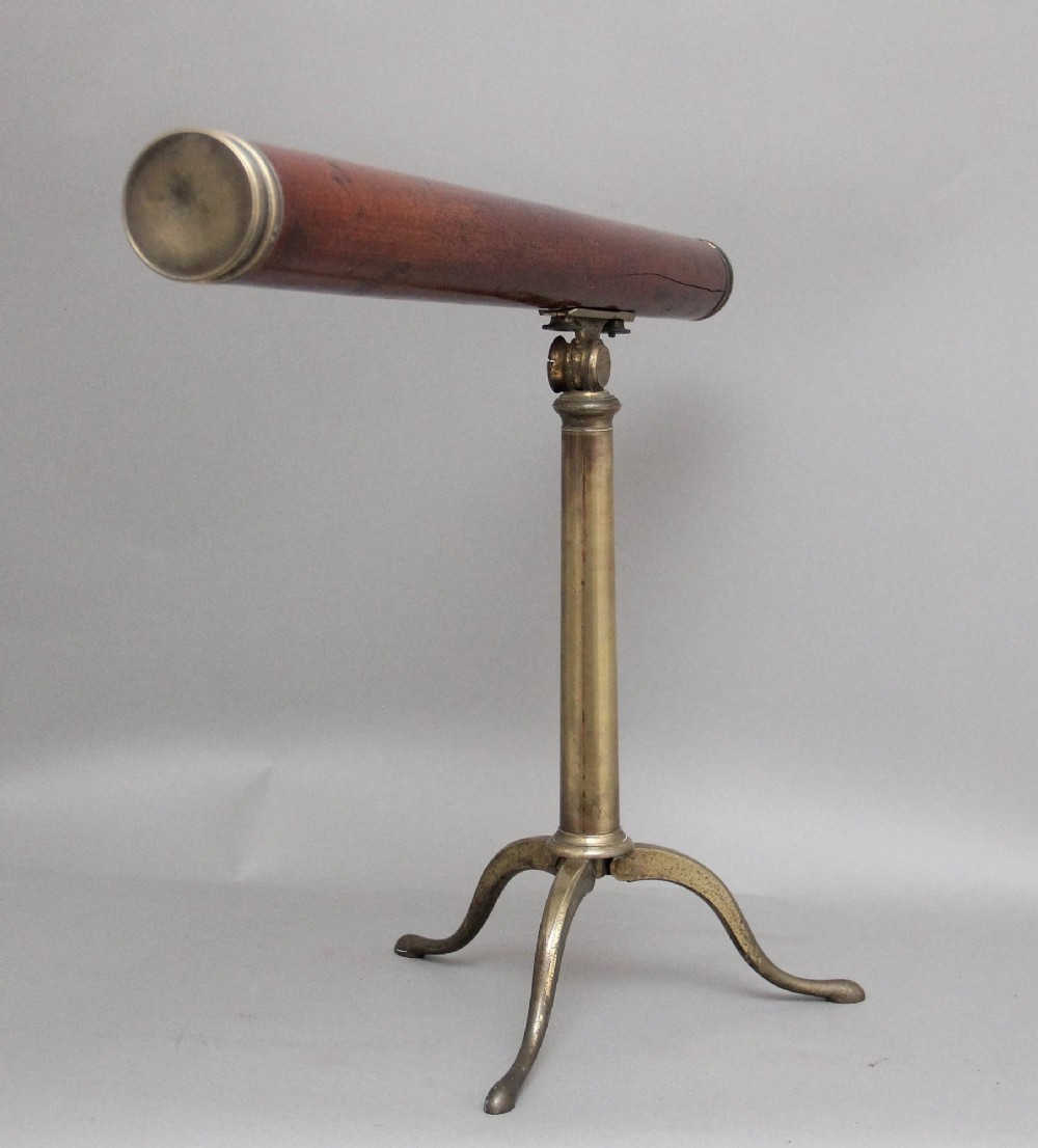 An 18th-century mahogany barrel telescope mounted on an adjustable brass column with a folding tripod base. View III