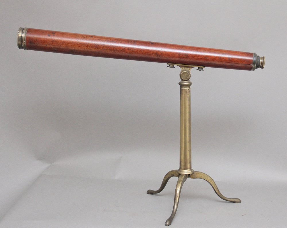 An 18th-century mahogany barrel telescope mounted on an adjustable brass column with a folding tripod base. View IV