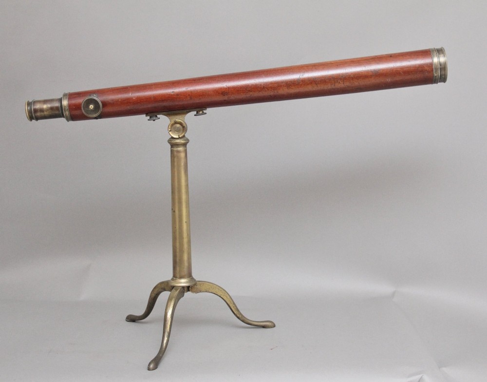 An 18th-century mahogany barrel telescope mounted on an adjustable brass column with a folding tripod base. View VI