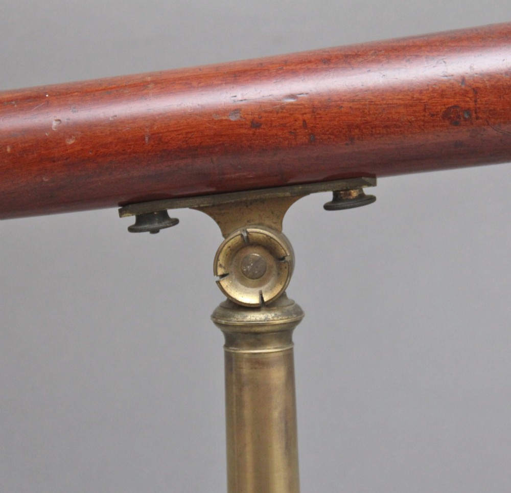 An 18th-century mahogany barrel telescope mounted on an adjustable brass column with a folding tripod base. View VIII