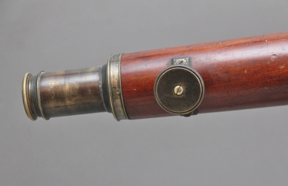 An 18th-century mahogany barrel telescope mounted on an adjustable brass column with a folding tripod base. View IX