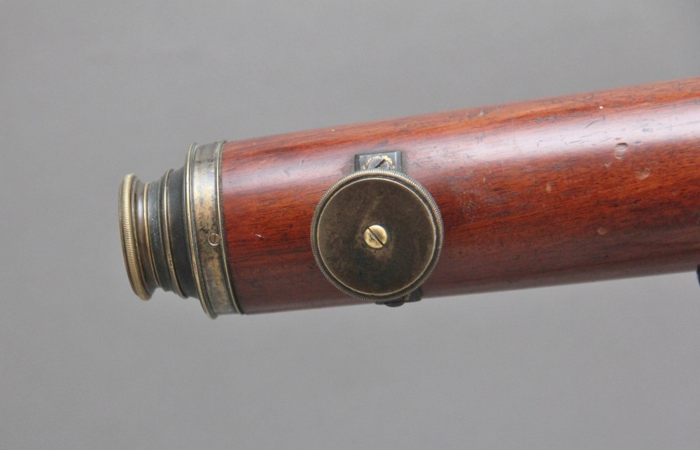 An 18th-century mahogany barrel telescope mounted on an adjustable brass column with a folding tripod base. View X