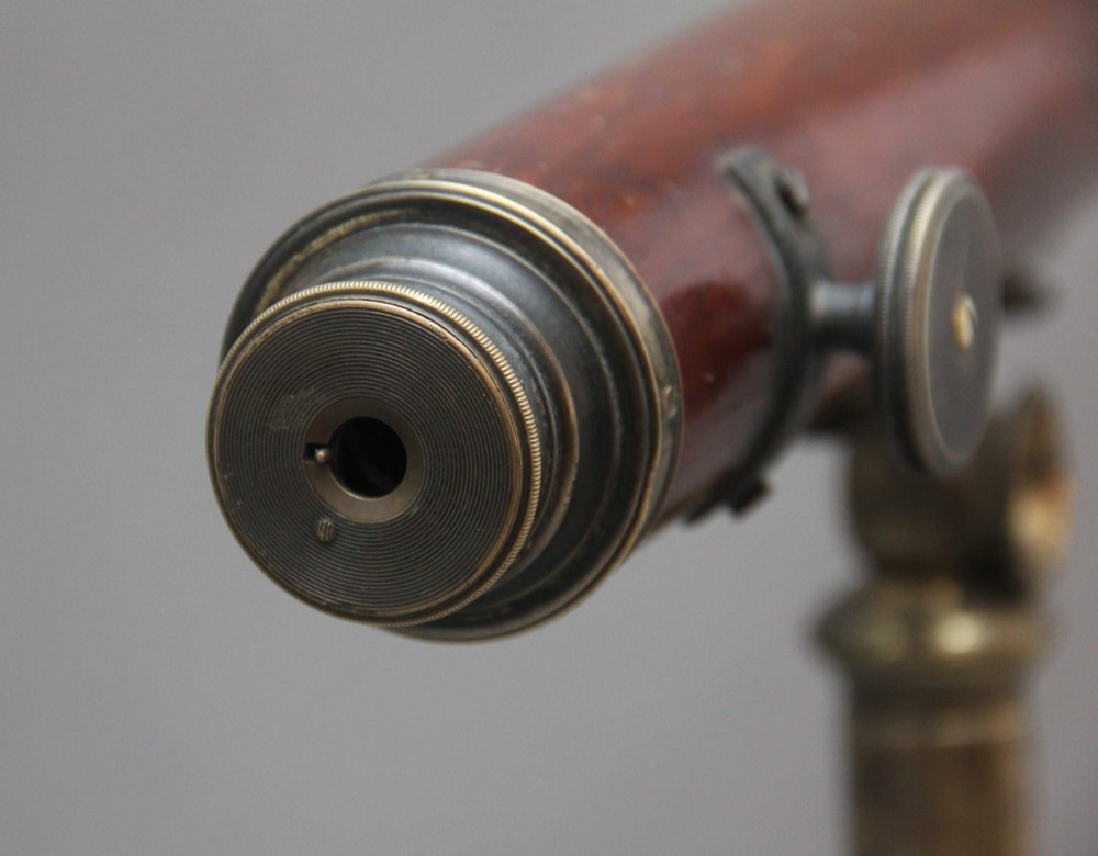 An 18th-century mahogany barrel telescope mounted on an adjustable brass column with a folding tripod base. View XI