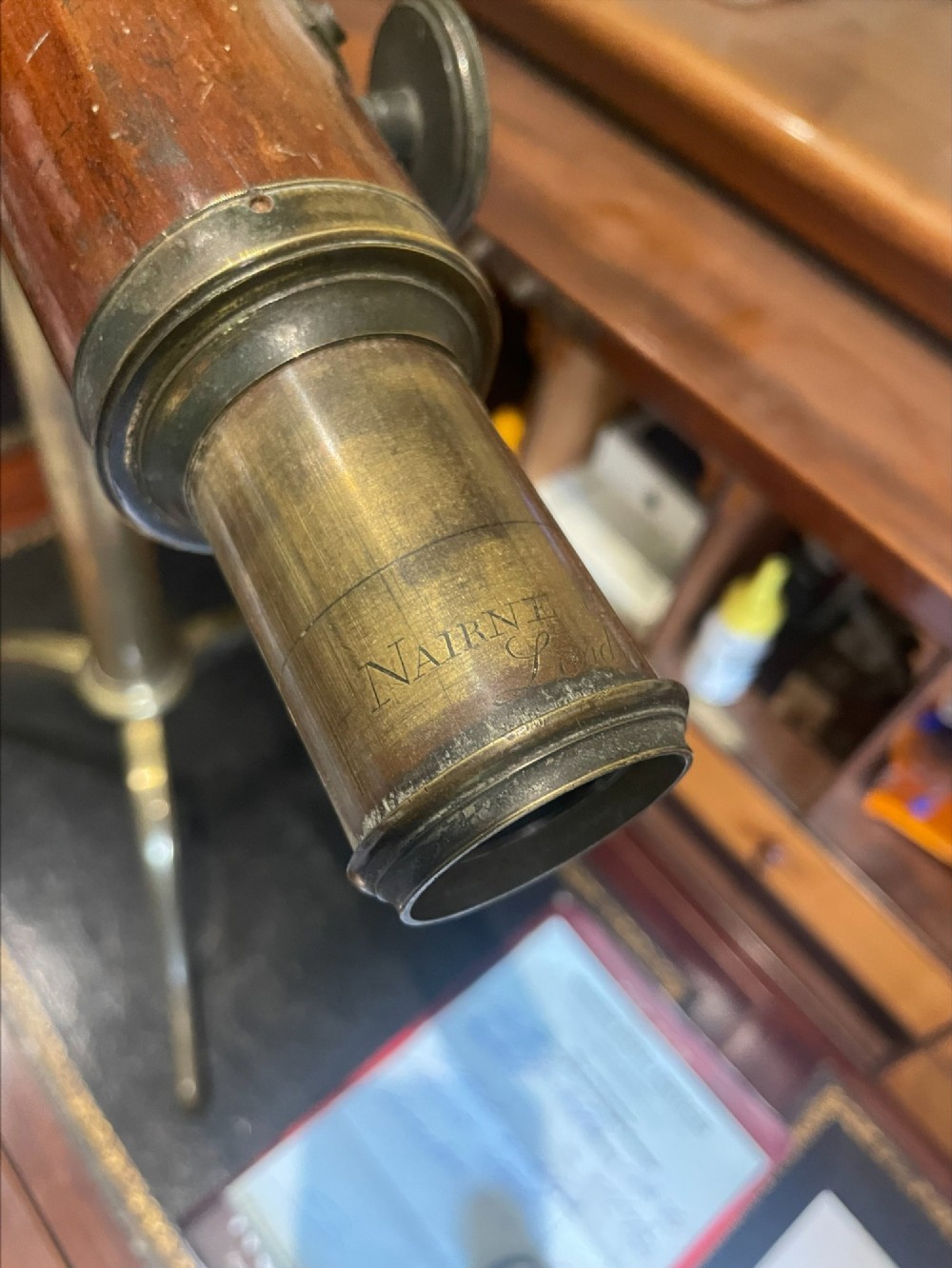 An 18th-century mahogany barrel telescope mounted on an adjustable brass column with a folding tripod base. View XIV