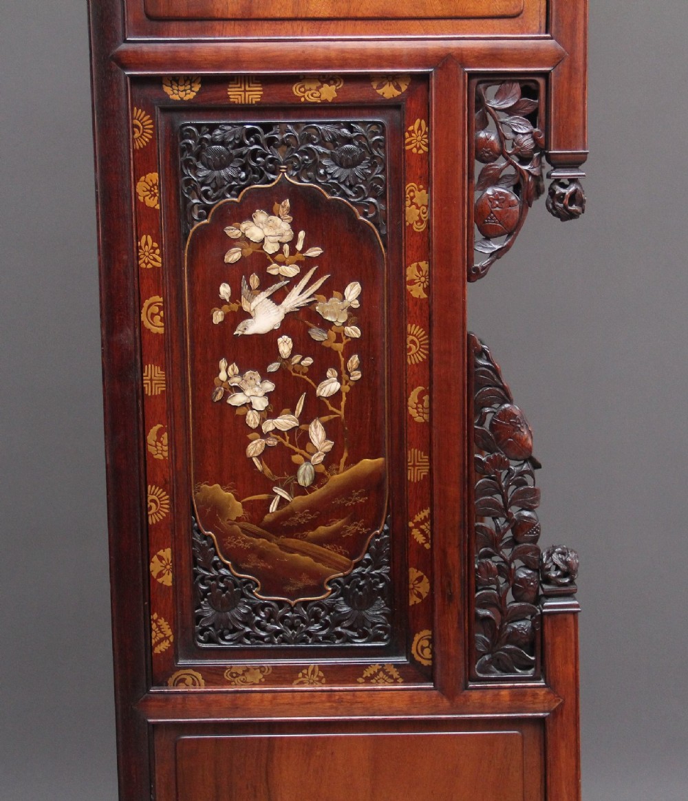 A large 19th-century Japanese hardwood Shodona cabinet featuring asymmetric shelves, carved dragon cresting, and panel doors adorned with lacquer and mother-of-pearl bird motifs. View VI
