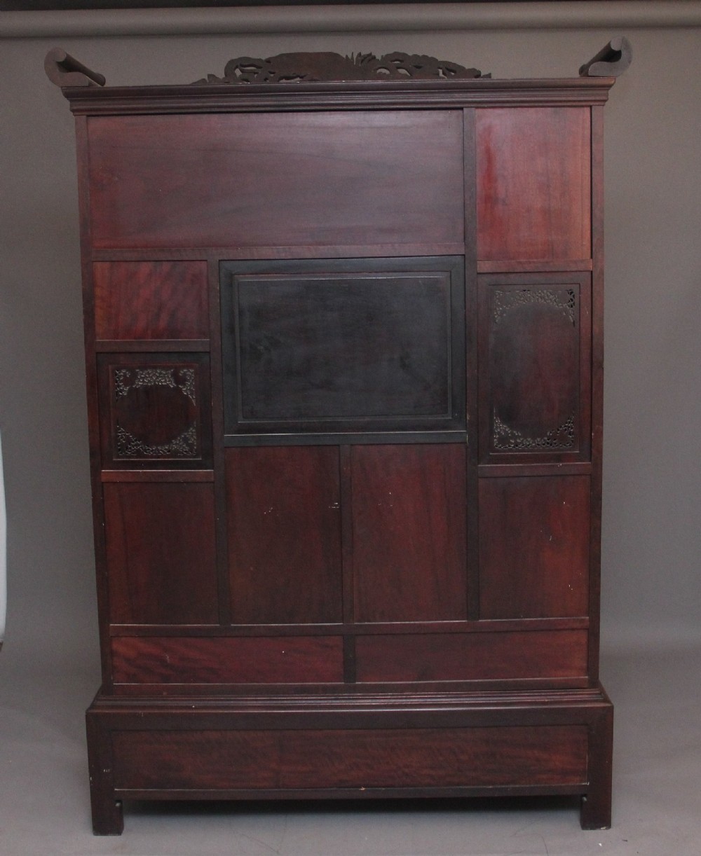 A large 19th-century Japanese hardwood Shodona cabinet featuring asymmetric shelves, carved dragon cresting, and panel doors adorned with lacquer and mother-of-pearl bird motifs. View VII