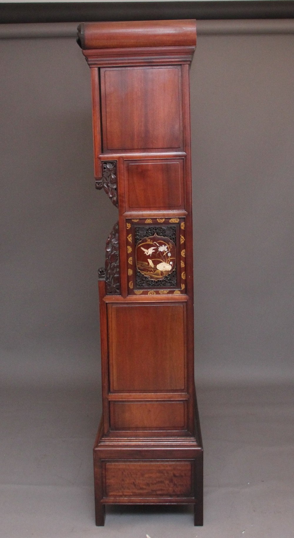 A large 19th-century Japanese hardwood Shodona cabinet featuring asymmetric shelves, carved dragon cresting, and panel doors adorned with lacquer and mother-of-pearl bird motifs. View IX