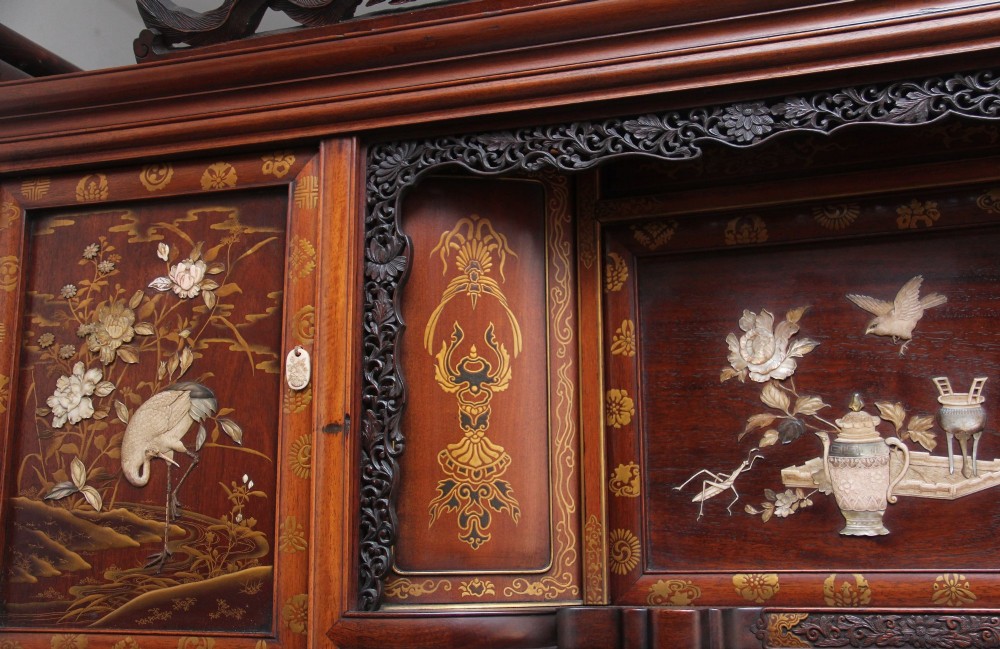 A large 19th-century Japanese hardwood Shodona cabinet featuring asymmetric shelves, carved dragon cresting, and panel doors adorned with lacquer and mother-of-pearl bird motifs. View XIII