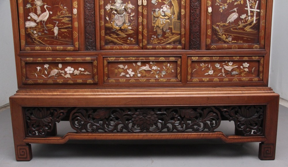 A large 19th-century Japanese hardwood Shodona cabinet featuring asymmetric shelves, carved dragon cresting, and panel doors adorned with lacquer and mother-of-pearl bird motifs. View XIV