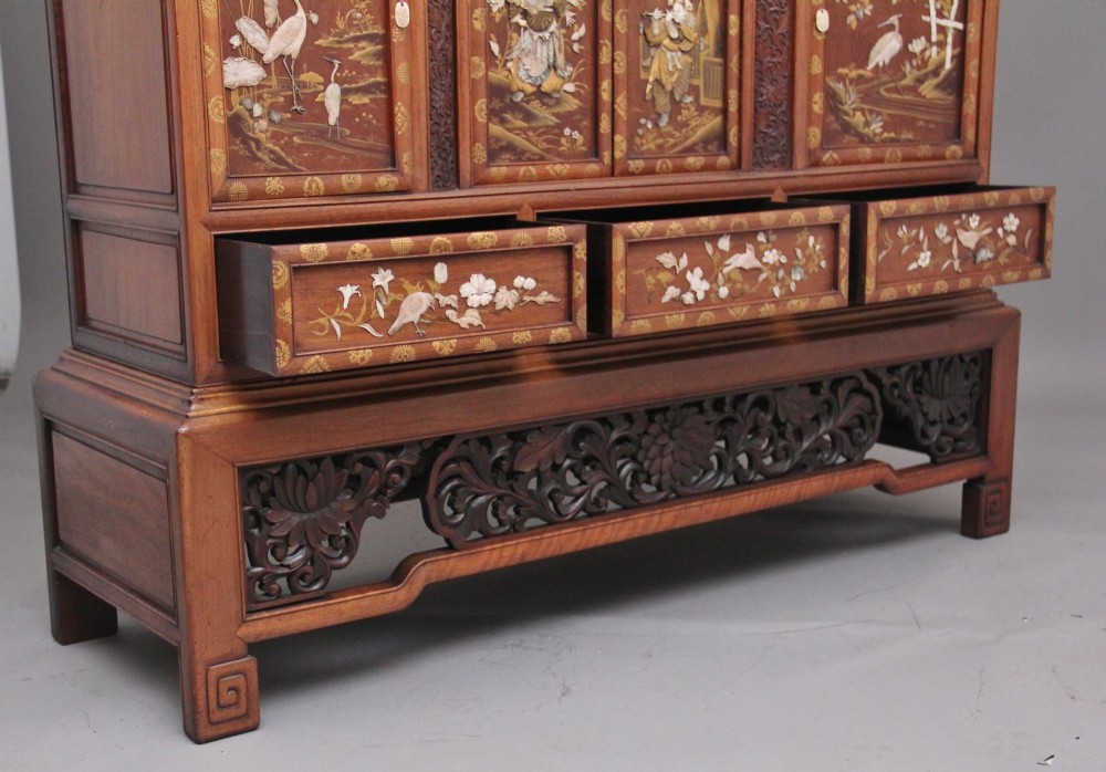 A large 19th-century Japanese hardwood Shodona cabinet featuring asymmetric shelves, carved dragon cresting, and panel doors adorned with lacquer and mother-of-pearl bird motifs. View XV