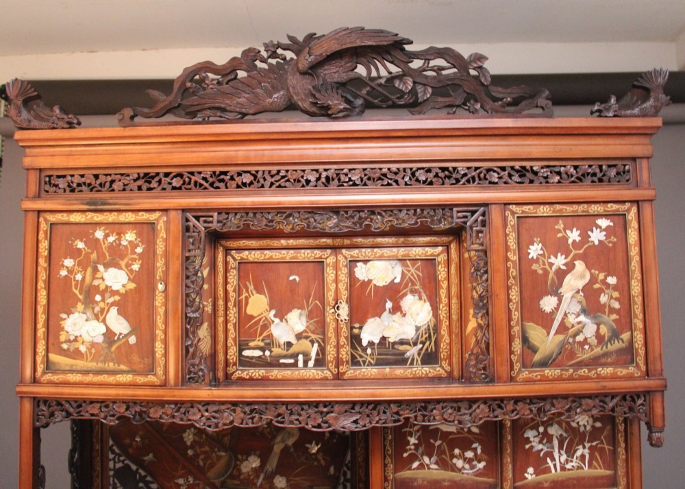A 19th-century Japanese Meiji period shodona display cabinet with asymmetrical lacquered doors, bird and floral shibayama inlays, and carved cresting. View VII