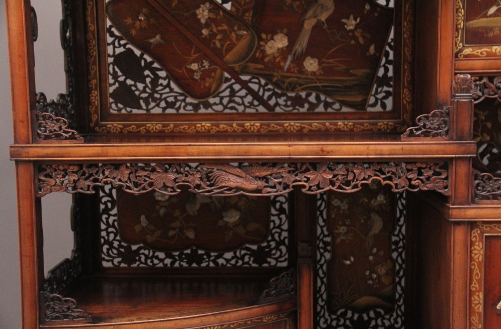 A 19th-century Japanese Meiji period shodona display cabinet with asymmetrical lacquered doors, bird and floral shibayama inlays, and carved cresting. View XII