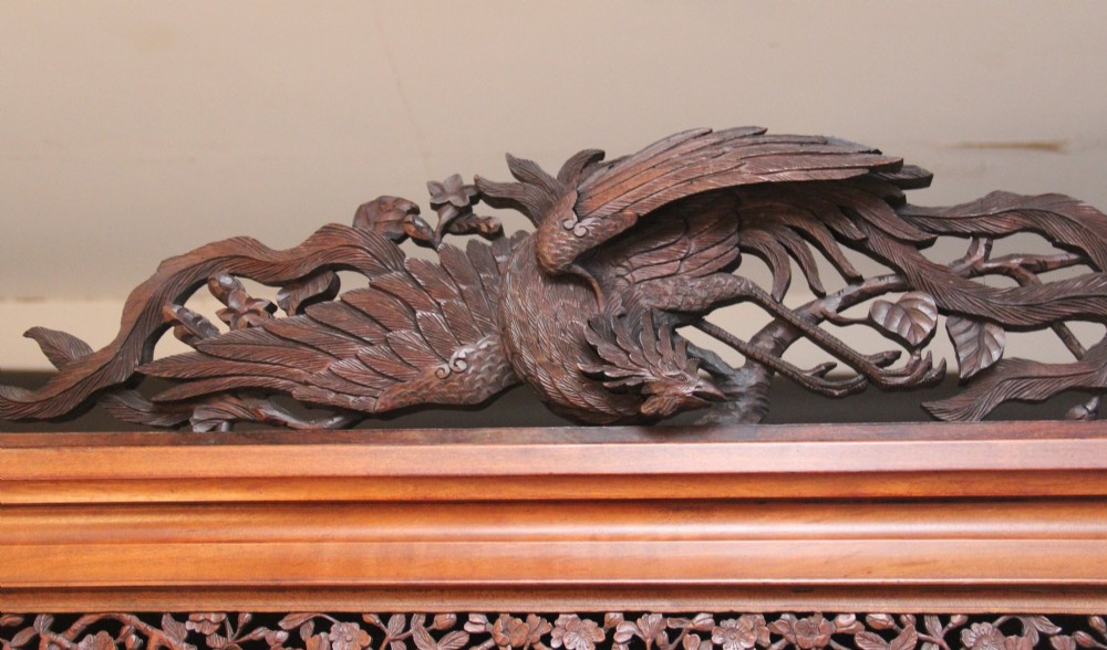A 19th-century Japanese Meiji period shodona display cabinet with asymmetrical lacquered doors, bird and floral shibayama inlays, and carved cresting. View XIII