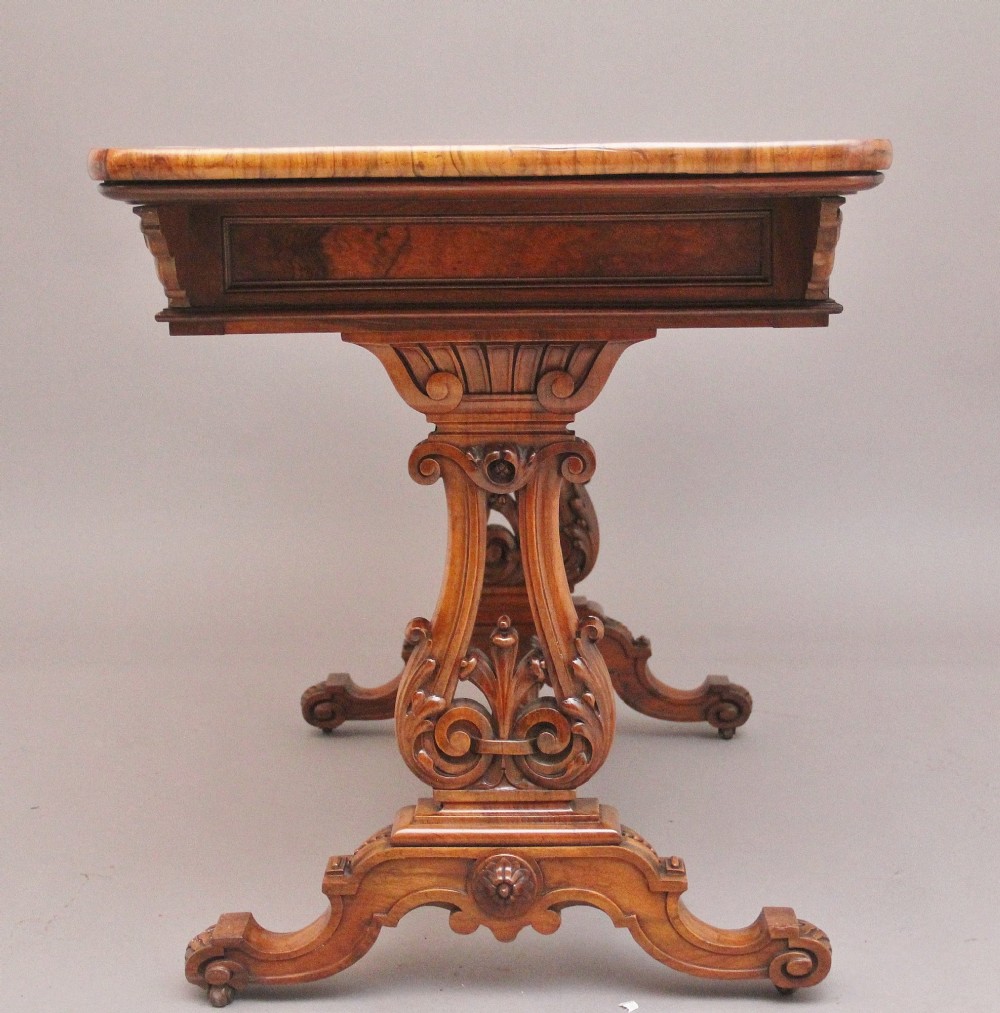 A 19th-century burr walnut library table with two frieze drawers, carved scroll brackets, dual pedestal legs, and a central turned stretcher. View VIII