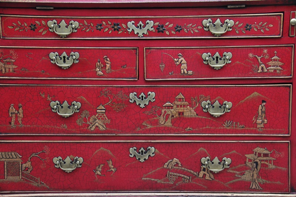An early twentieth-century red lacquered Chinoiserie bureau bookcase decorated with gilded landscapes, double glazed doors, and brass drop handles. View VI