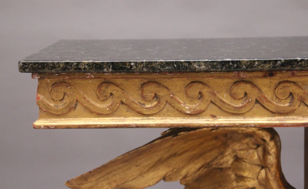 An early 20th-century console table featuring a dark marble top supported by a carved golden eagle pedestal on a matching marble base. View XIII