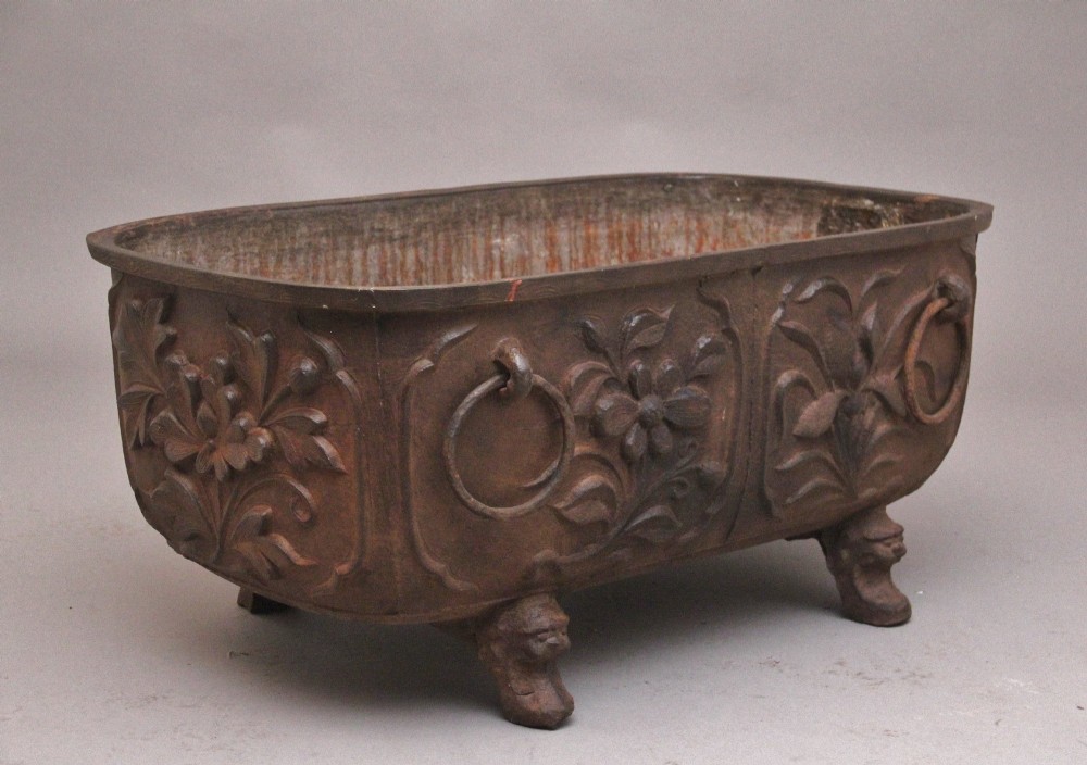 An early nineteenth-century Chinese cast iron temple bath featuring raised floral carvings, side ring handles, and lion mask feet.
