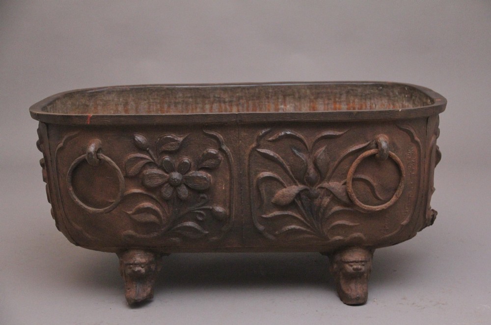 An early nineteenth-century Chinese cast iron temple bath featuring raised floral carvings, side ring handles, and lion mask feet. View II