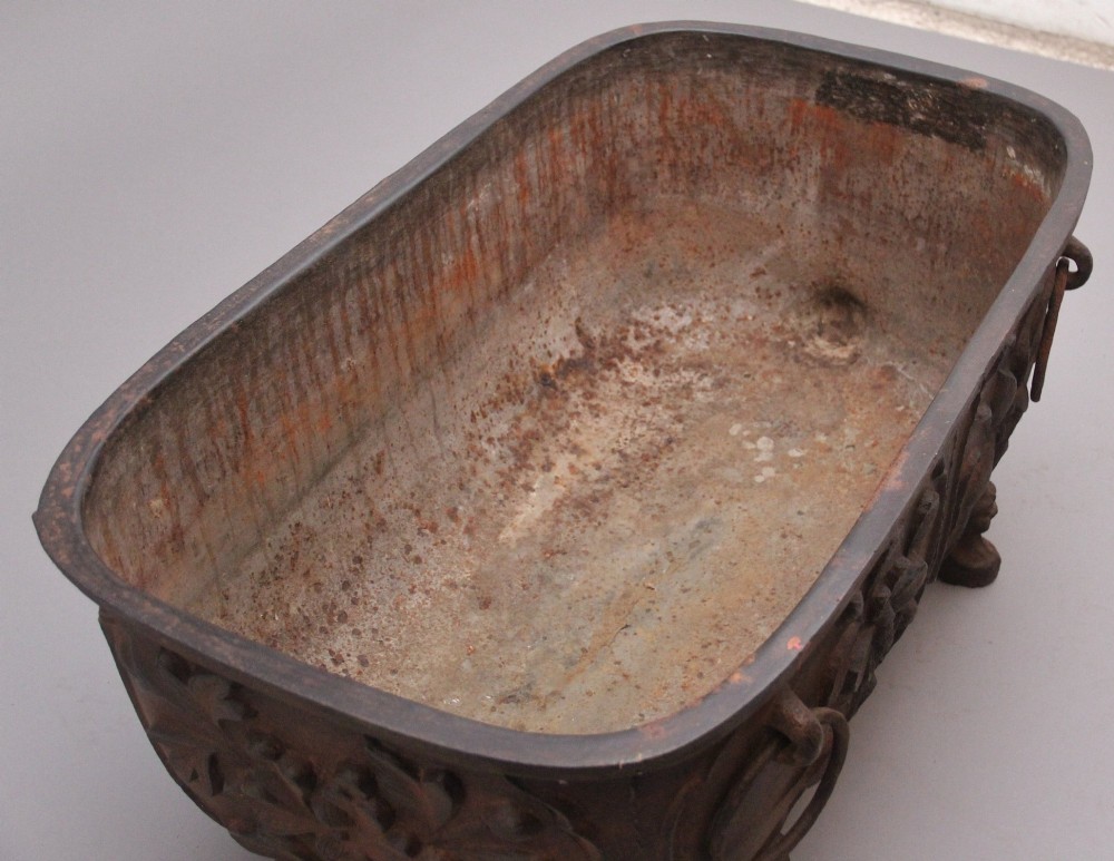 An early nineteenth-century Chinese cast iron temple bath featuring raised floral carvings, side ring handles, and lion mask feet. View III