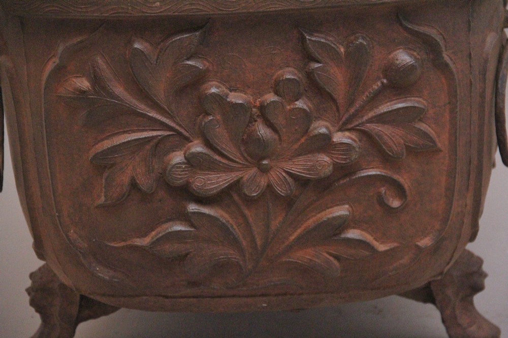 An early nineteenth-century Chinese cast iron temple bath featuring raised floral carvings, side ring handles, and lion mask feet. View V