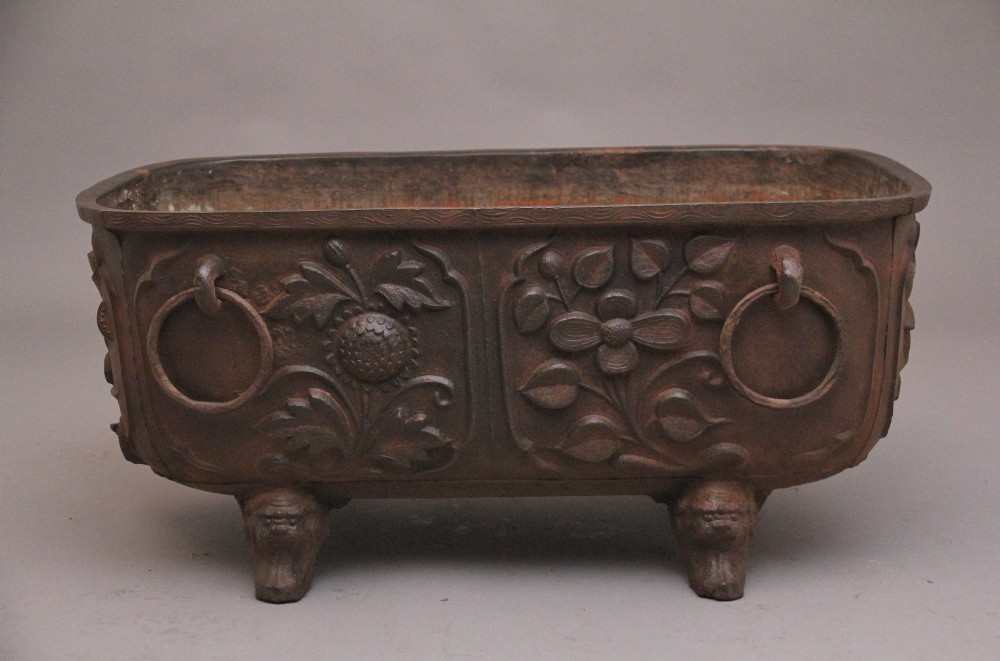 An early nineteenth-century Chinese cast iron temple bath featuring raised floral carvings, side ring handles, and lion mask feet. View VI