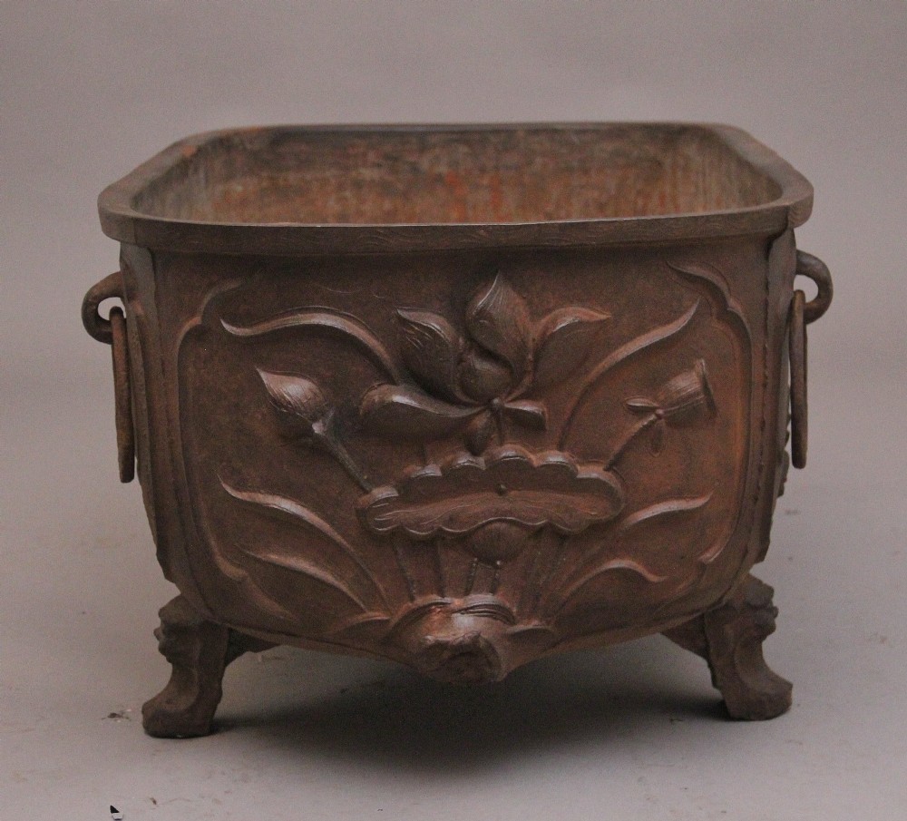 An early nineteenth-century Chinese cast iron temple bath featuring raised floral carvings, side ring handles, and lion mask feet. View VII