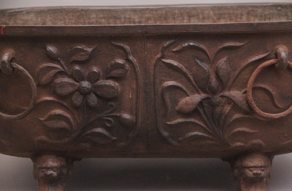 An early nineteenth-century Chinese cast iron temple bath featuring raised floral carvings, side ring handles, and lion mask feet. View IX