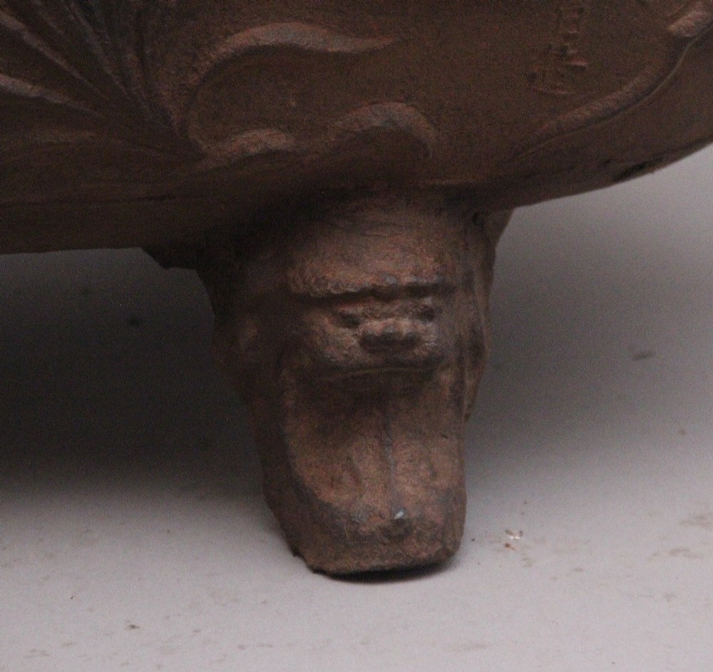An early nineteenth-century Chinese cast iron temple bath featuring raised floral carvings, side ring handles, and lion mask feet. View XI