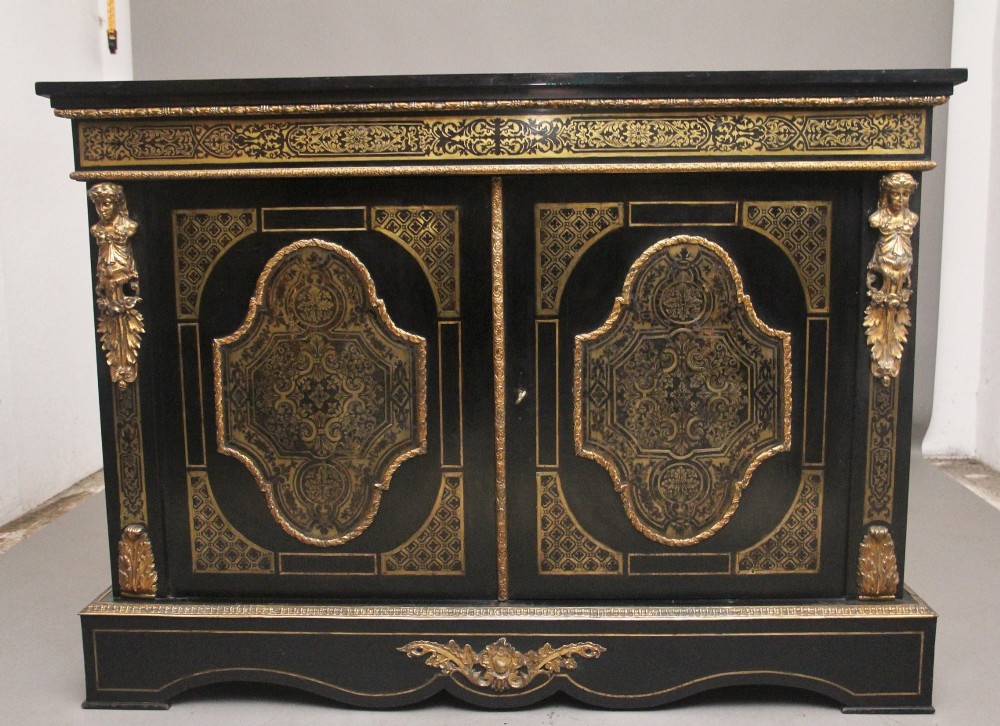 A 19th-century ebonised two-door cabinet featuring detailed brass Boulle marquetry panels, classical female caryatid mounts, and gilt-bronze mouldings.