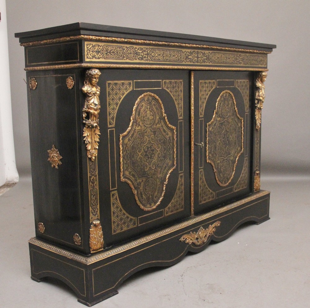 A 19th-century ebonised two-door cabinet featuring detailed brass Boulle marquetry panels, classical female caryatid mounts, and gilt-bronze mouldings. View III