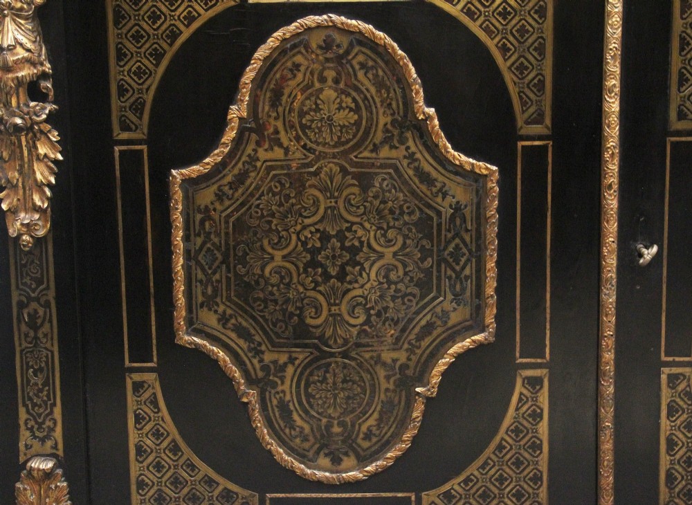 A 19th-century ebonised two-door cabinet featuring detailed brass Boulle marquetry panels, classical female caryatid mounts, and gilt-bronze mouldings. View IV