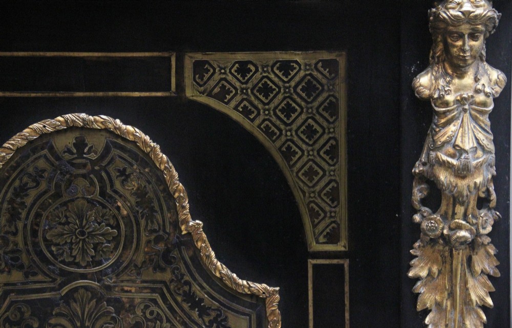 A 19th-century ebonised two-door cabinet featuring detailed brass Boulle marquetry panels, classical female caryatid mounts, and gilt-bronze mouldings. View V