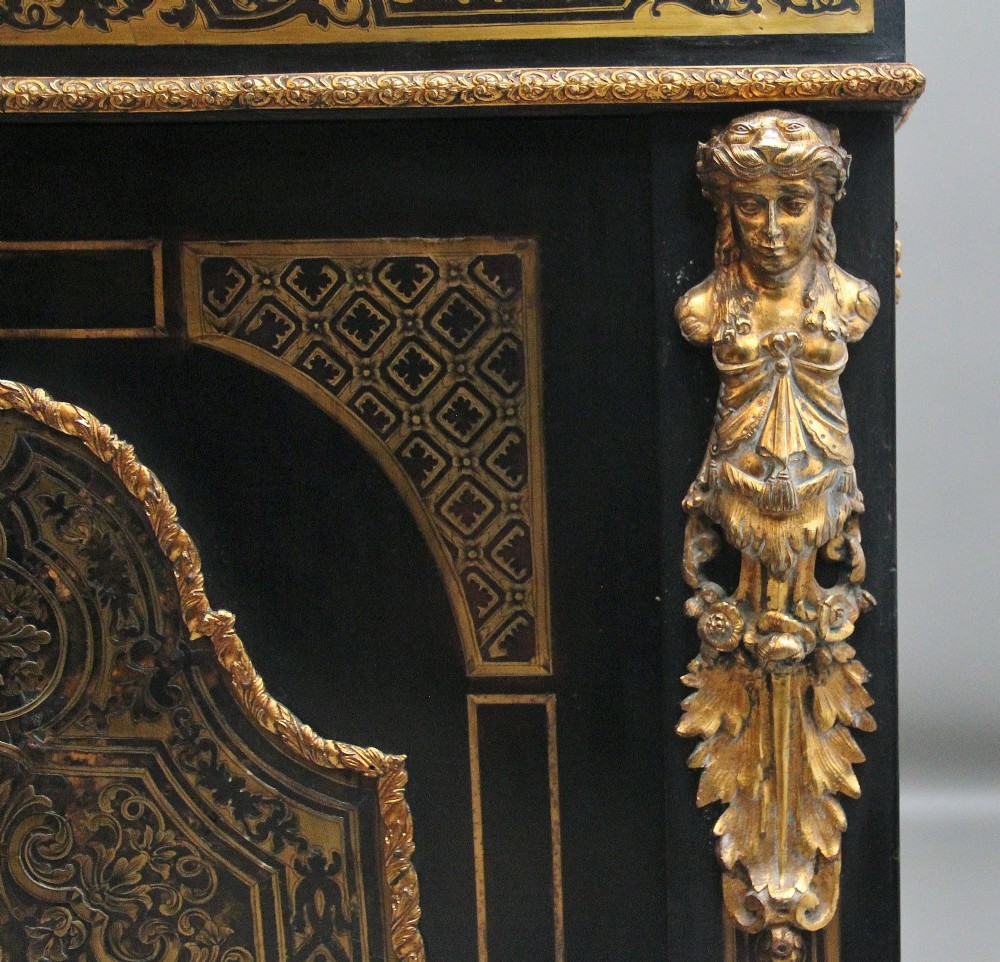 A 19th-century ebonised two-door cabinet featuring detailed brass Boulle marquetry panels, classical female caryatid mounts, and gilt-bronze mouldings. View VI