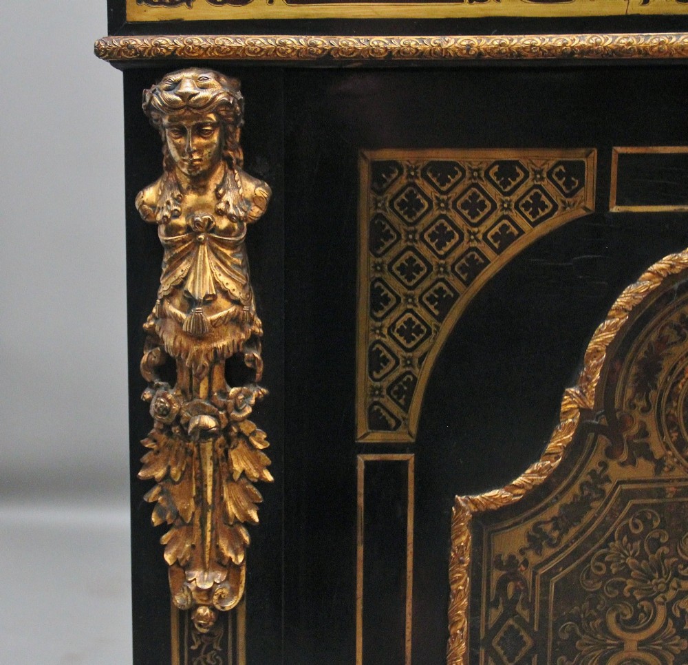 A 19th-century ebonised two-door cabinet featuring detailed brass Boulle marquetry panels, classical female caryatid mounts, and gilt-bronze mouldings. View IX