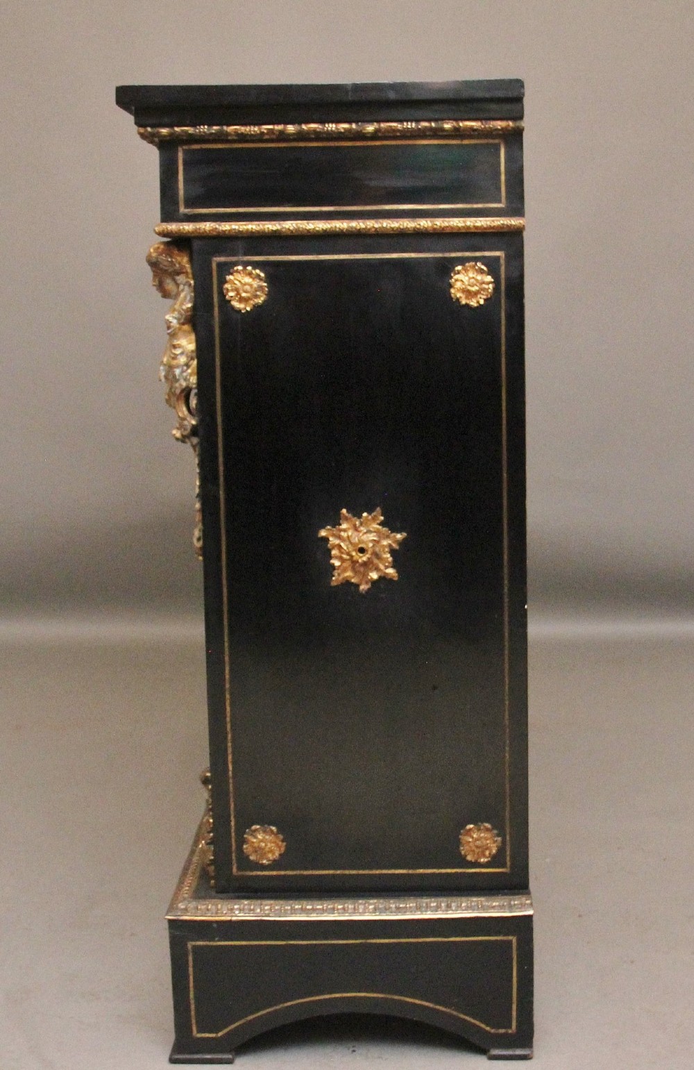 A 19th-century ebonised two-door cabinet featuring detailed brass Boulle marquetry panels, classical female caryatid mounts, and gilt-bronze mouldings. View X