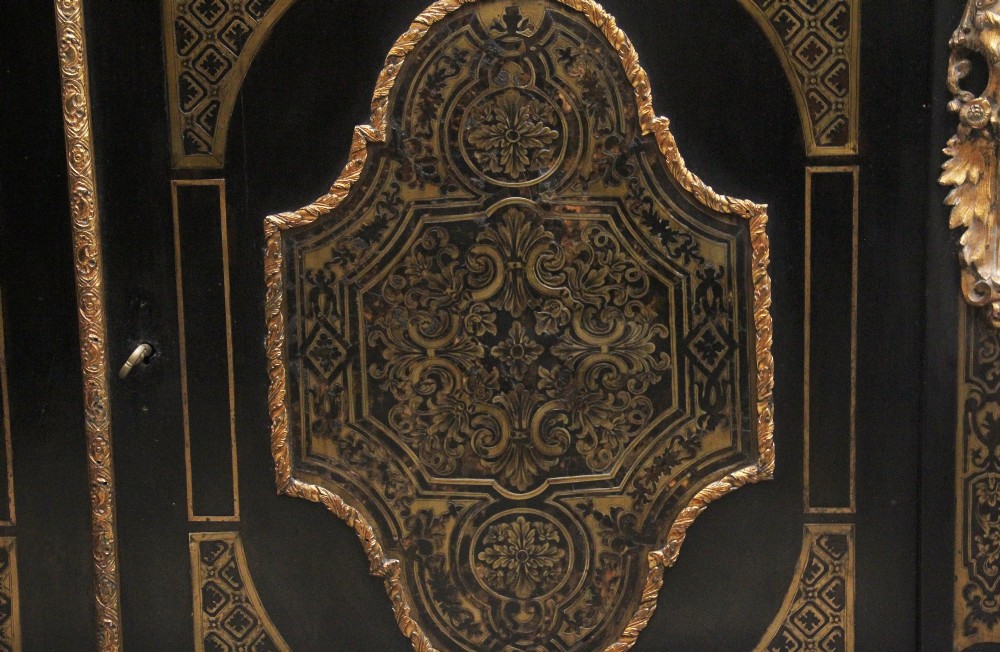 A 19th-century ebonised two-door cabinet featuring detailed brass Boulle marquetry panels, classical female caryatid mounts, and gilt-bronze mouldings. View XIV