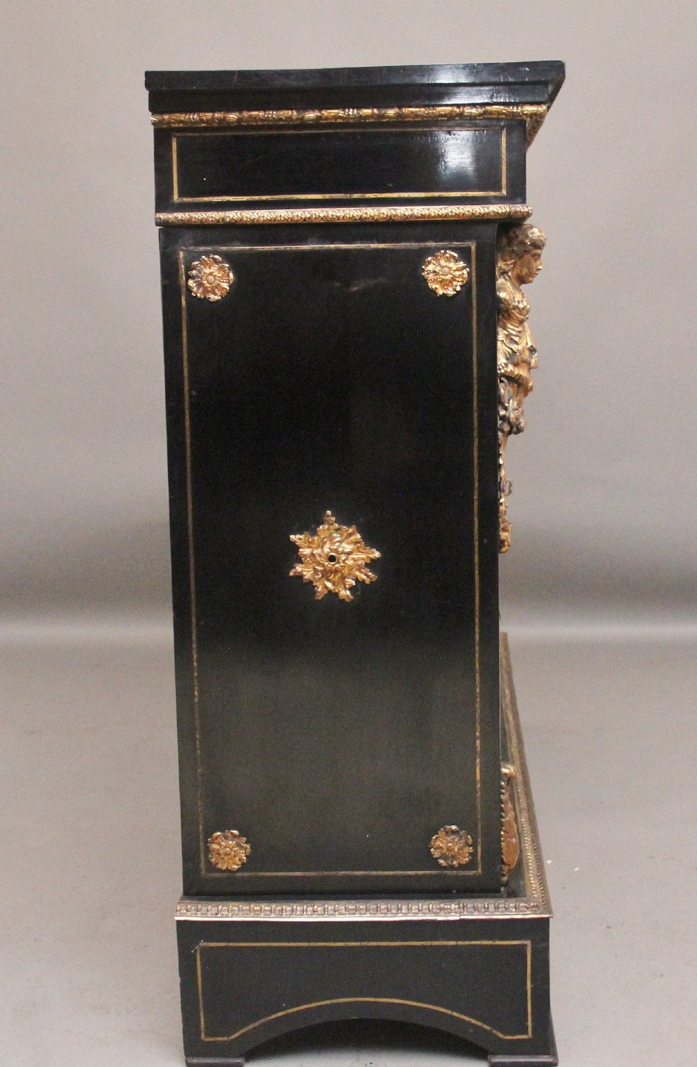 A 19th-century ebonised two-door cabinet featuring detailed brass Boulle marquetry panels, classical female caryatid mounts, and gilt-bronze mouldings. View XV
