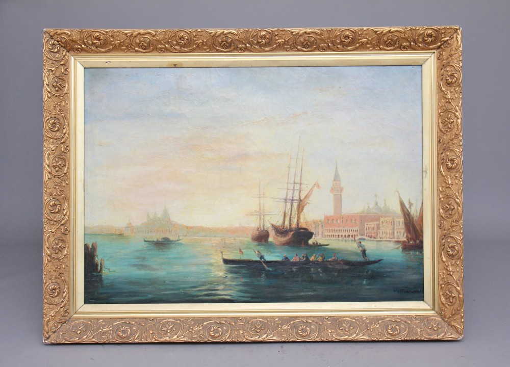 An early 20th-century oil painting depicting gondolas and ships on the Venetian lagoon, set within an ornate gilded frame.
